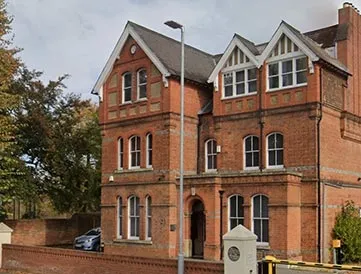 Picture of a red bricked house which is the Forbury Clinic